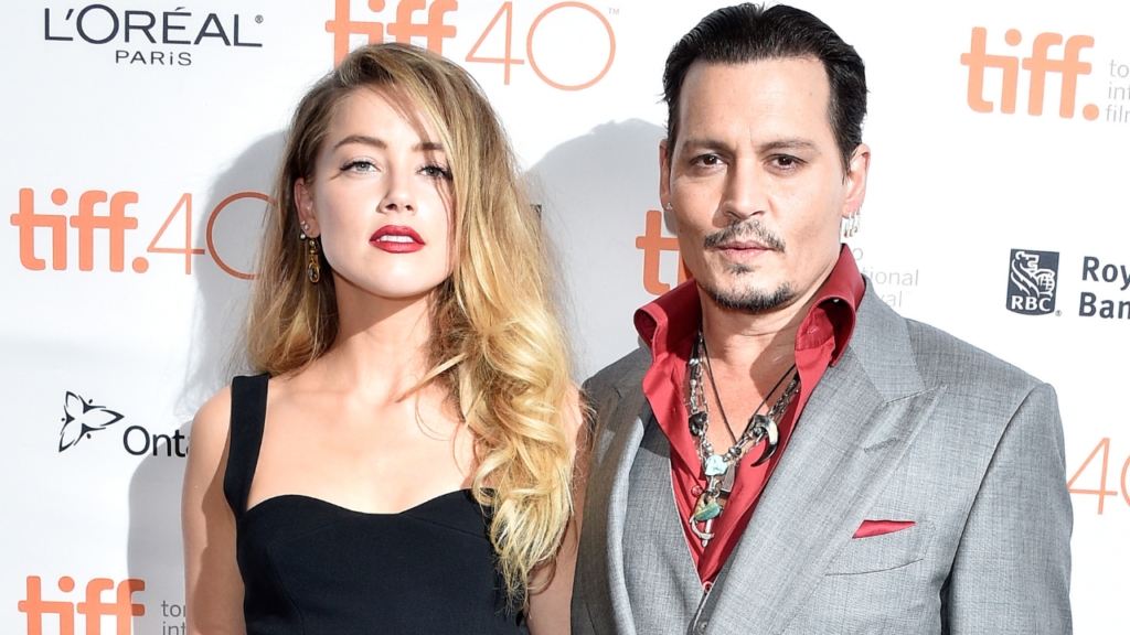 A photo of Amber Heard (left) and Johnny Depp (right) standing together.